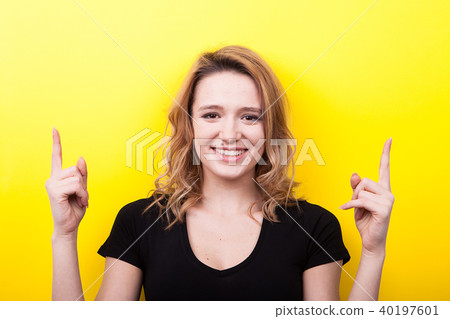 Happy smiling woman pointing up 40197601