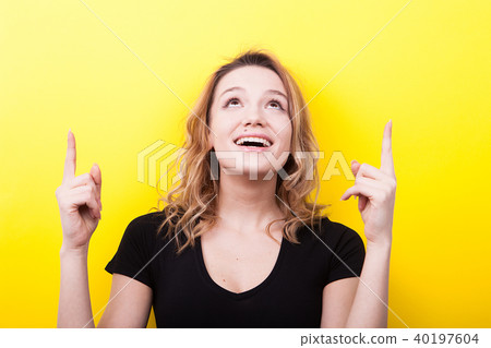 Happy smiling woman pointing up 40197604