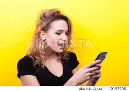 Surprised woman with a phone in hands Surprised woman with a phone in hands 40197608