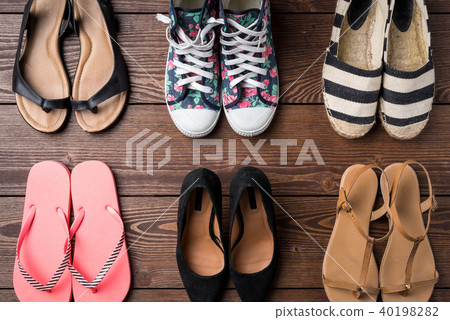 Collection of women's shoes on wooden background Collection of women's shoes on wooden background 40198282