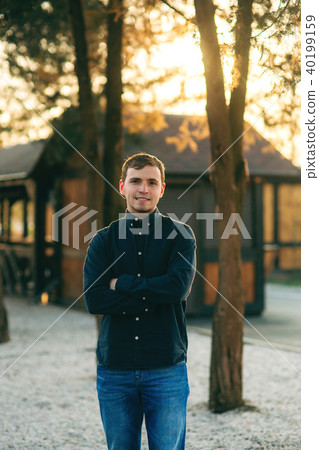 A young man in a park in a dark blue shirt. Spring A young man in a park in a dark blue shirt. Spring 40199159