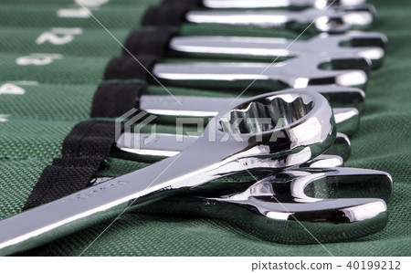 Open-end wrench set on green cover. 40199212