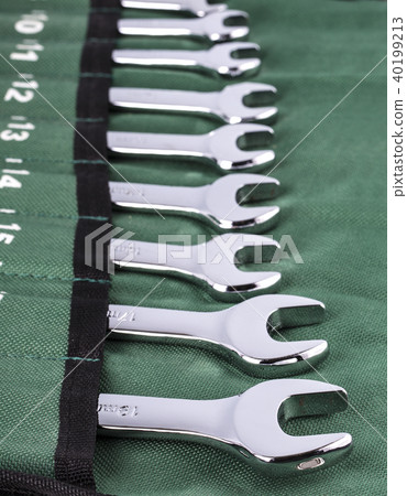 Open-end wrench set on green cover. 40199213