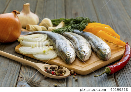 Raw fish on kitchen table with ingredients Raw fish on kitchen table with ingredients 40199218