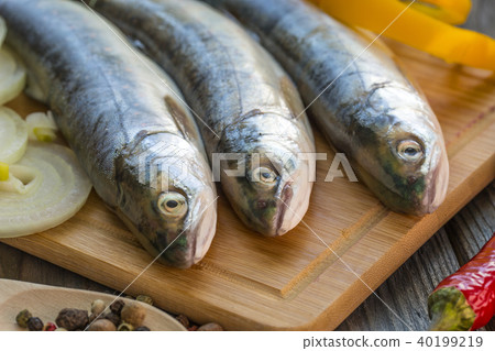 Raw fish on kitchen table with ingredients Raw fish on kitchen table with ingredients 40199219