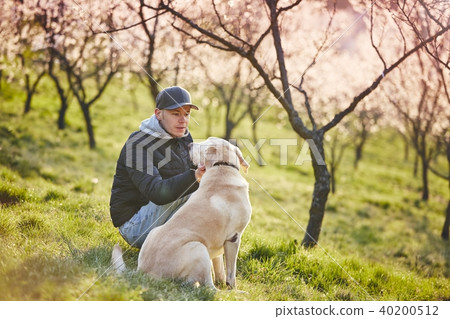 Man with dog in spring nature 40200512