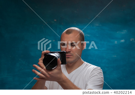 Cute man posing on blue background Cute man posing on blue background 40202214