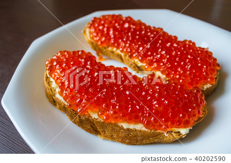 Red caviar on bread. 40202590