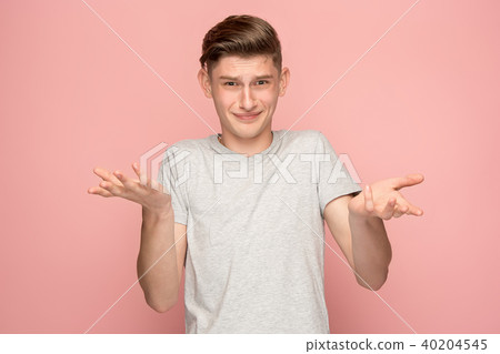 Suspiciont. Doubtful pensive man with thoughtful expression making choice against pink background Suspiciont. Doubtful pensive man with thoughtful expression making choice against pink background 40204545