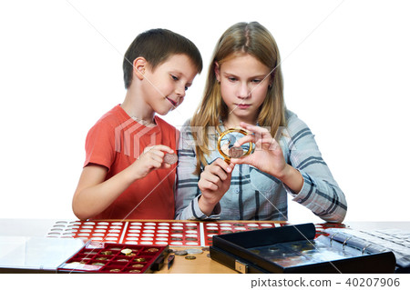 Boy and girl are considering coin collection 40207906