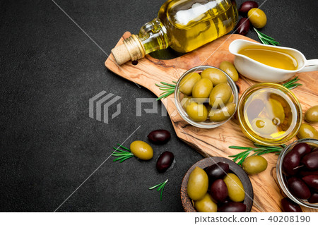 black and green olives and oil on wooden cutting board black and green olives and oil on wooden cutting board 40208190