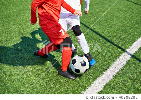 Child soccer players and ball on football field Child soccer players and ball on football field 40208295