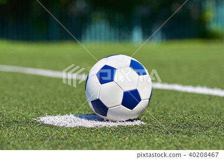 Soccer ball on grass of football stadium 40208467