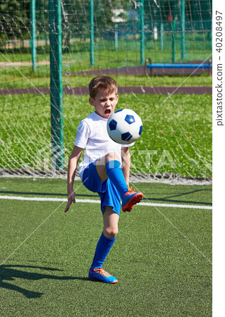 Football player training with ball on green lawn Football player training with ball on green lawn 40208497