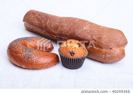 Many mixed breads and muffins on white background. 40209368