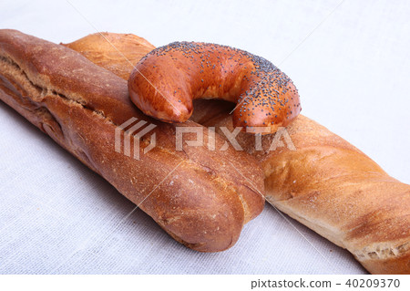 Many mixed breads and muffins on white background. 40209370