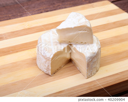 Cheese with white mold. Camembert or brie type on wood table. Healthy breakfast. Cheese with white mold. Camembert or brie type on wood table. Healthy breakfast. 40209904