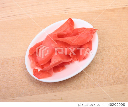 plate with Japanese pickled ginge on wood background. plate with Japanese pickled ginge on wood background. 40209908