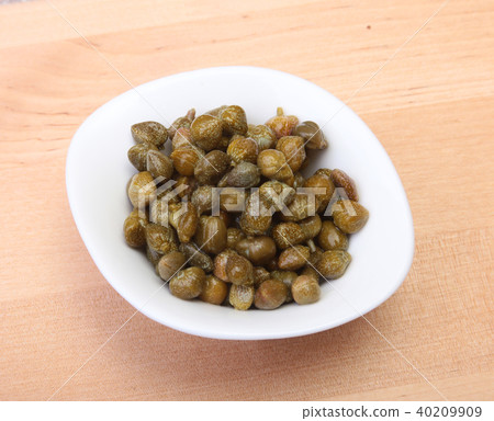 bowl with fresh capers on wooden table bowl with fresh capers on wooden table 40209909