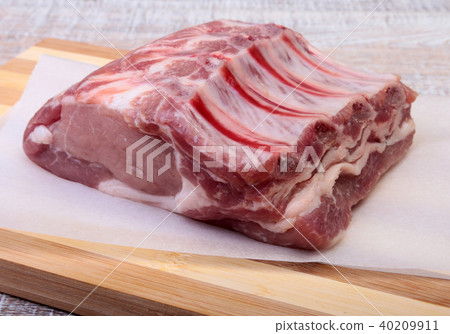 Raw pork chops, spices on cutting board. Ready for cooking. Raw pork chops, spices on cutting board. Ready for cooking. 40209911