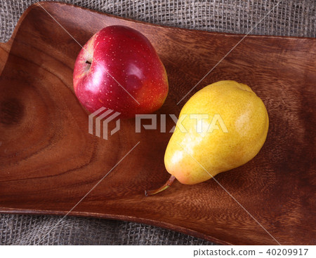 Fresh organic fruits on wooden Serving tray. Assorted pear and apple. Fresh organic fruits on wooden Serving tray. Assorted pear and apple. 40209917