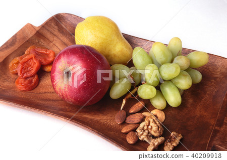 Fresh organic fruits on wood Serving tray. Assorted apple, pear and grapes. Fresh organic fruits on wood Serving tray. Assorted apple, pear and grapes. 40209918