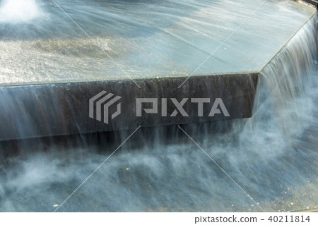 Water flowing in city fountain 40211814
