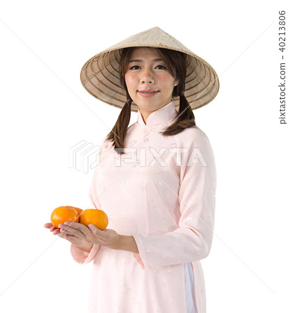 woman in pink dress and vietnam hat holding orange woman in pink dress and vietnam hat holding orange 40213806