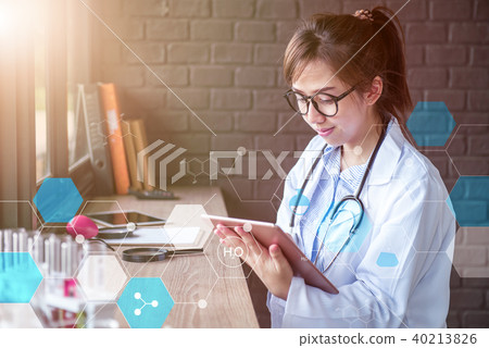 Doctor working on internet in lap test.  40213826
