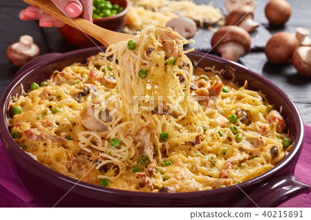 holding a fork with portion of Tetrazzini holding a fork with portion of Tetrazzini 40215891