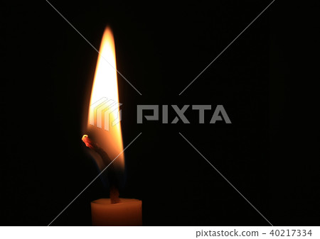 Candle flame burning on black background. Candle flame burning on black background. 40217334