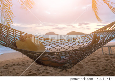 Happy woman relaxing in hammock 40219618