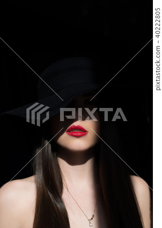The ray of the sun lights the girl in the dark. 40222805