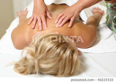 Masseur doing massage on woman body in the spa salon Masseur doing massage on woman body in the spa salon 40223310