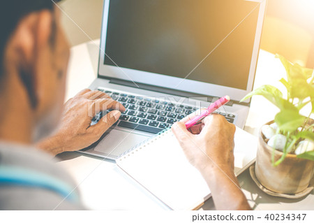Asian young businessman working on his laptop. Dig Asian young businessman working on his laptop. Dig 40234347