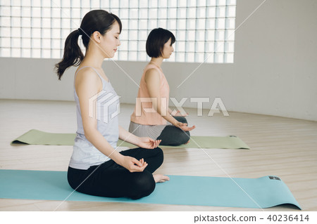 Young Japanese woman taking yoga lesson in yoga studio Young Japanese woman taking yoga lesson in yoga studio 40236414