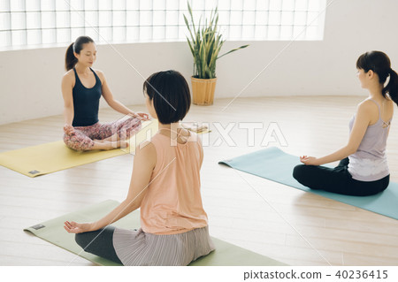Young Japanese woman taking yoga lesson in yoga studio Young Japanese woman taking yoga lesson in yoga studio 40236415
