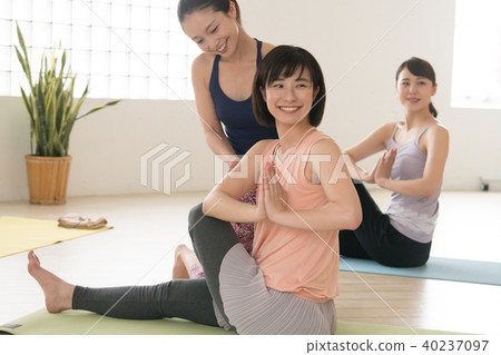 Young Japanese woman taking yoga lesson in yoga studio 40237097