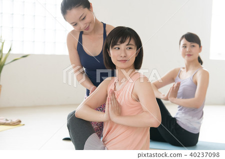 Young Japanese woman taking yoga lesson in yoga studio 40237098