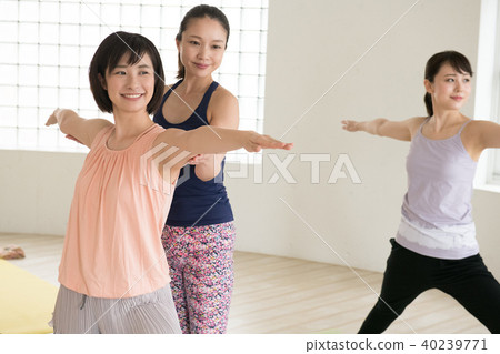 Young Japanese woman and instructor taking yoga lessons at yoga studio 40239771