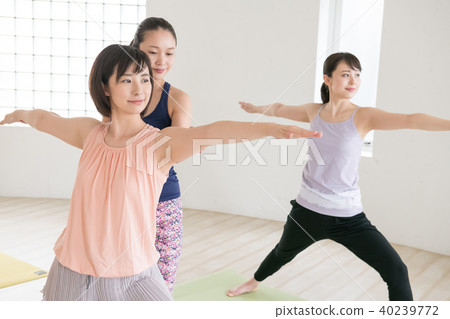 Young Japanese woman and instructor taking yoga lessons at yoga studio Young Japanese woman and instructor taking yoga lessons at yoga studio 40239772