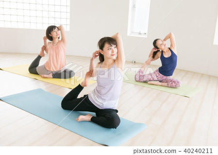 Young Japanese woman taking yoga lesson in yoga studio 40240211