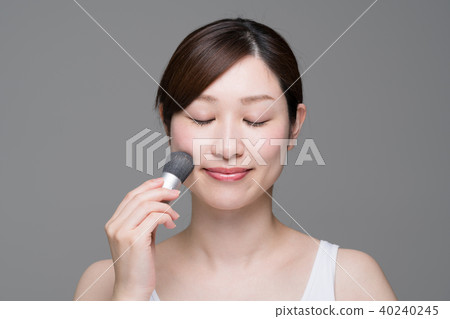 Woman doing makeup, foundation, brush Woman doing makeup, foundation, brush 40240245