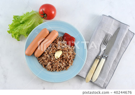 buckwheat and sausages with butter and ketchup buckwheat and sausages with butter and ketchup 40244676