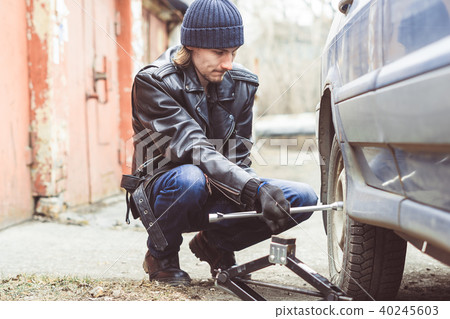 man changing wheel on a car 40245603