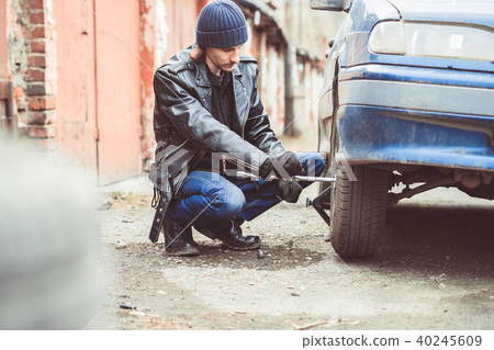 man changing wheel on a car 40245609