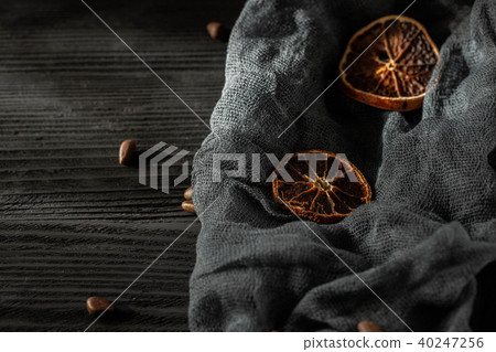 Dried oranges against a dark background with pine Dried oranges against a dark background with pine 40247256