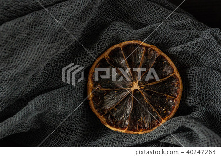 A segment of a lemon which was dried up under natu 40247263