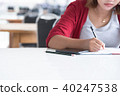 Asian woman writing at library. 40247538