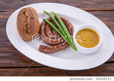 The chicken sausage fried with green onions is ser The chicken sausage fried with green onions is ser 40248313